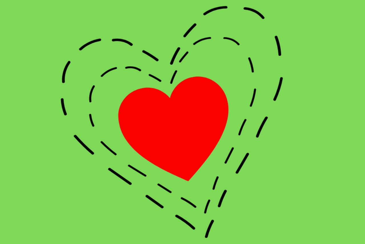 Red heart inside two larger hearts composed of dashed lines, all on a green background.