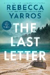 Book cover The Last Letter by Rebecca Yarros, featuring dog tags on a sandy beach, mountains and trees in the background. 