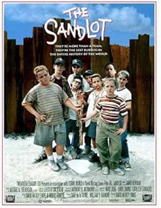 Poster for the movie "The Sandlot" featuring a group of kids standing in front of a wooden fence and holding a baseball bat.