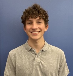 Coen, a young adult man with curly brown hair and an engaging smile.