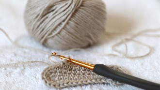 Grey yarn and a crochet hook