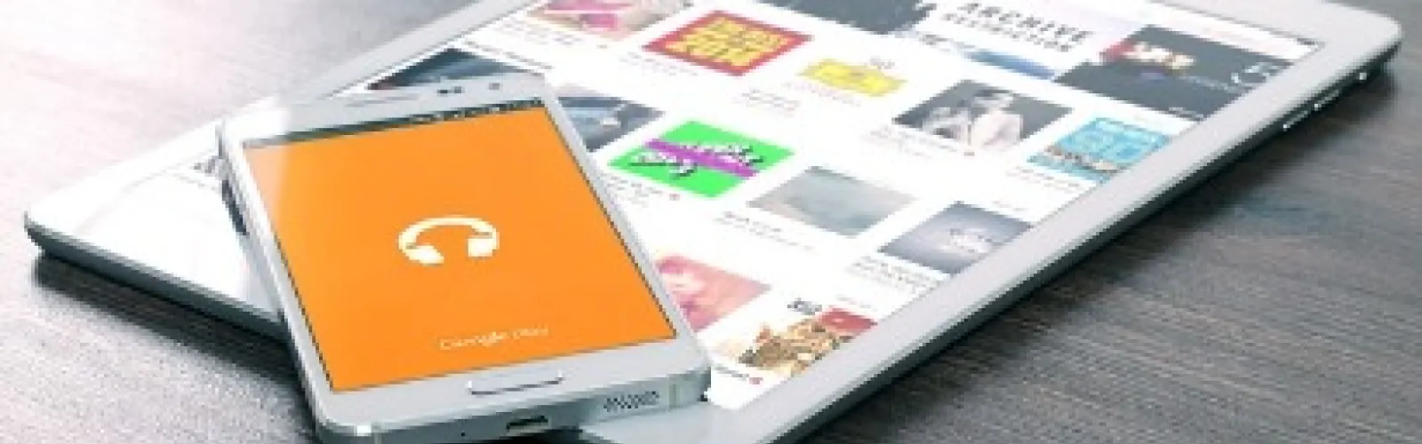 Cell phone lying on top of a tablet